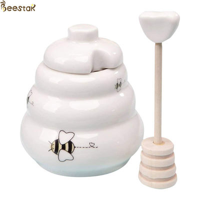vaso del miele della porcellana e vaso bianco ceramico del miele del cucchiaio con il coperchio